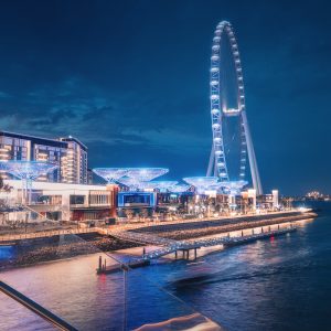 A contemporary architectural marvel featuring a colossal Ferris wheel on Blue Waters Island